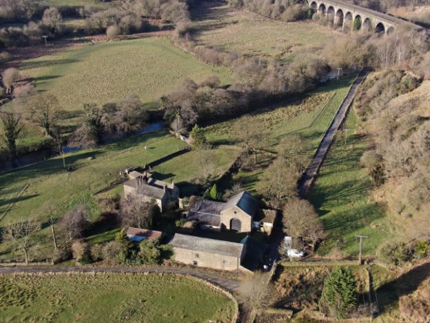 Aerial shot of Goytside Farm complex with viaduct in the distance taken 2022