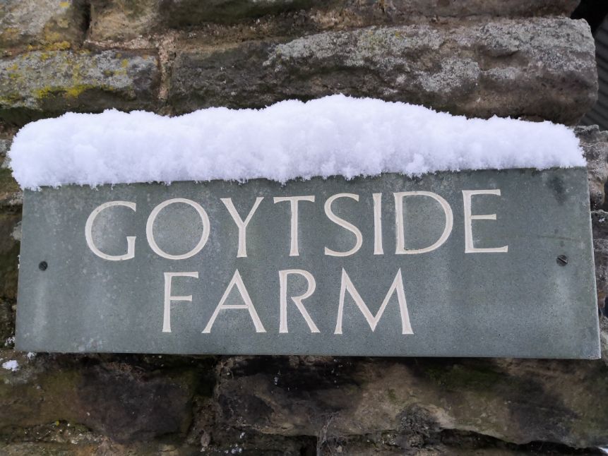 Slate Goytside Farm sign with a covering of snow