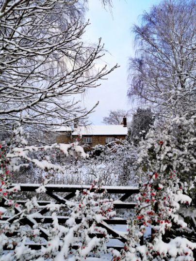 Goytside Farmhouse in the snow looking over the front gate