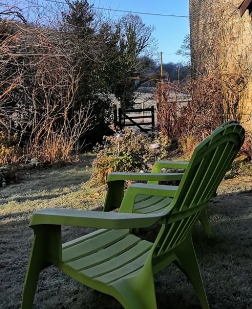 Green Adirondack chairs on frosty autumn morning at Goytside