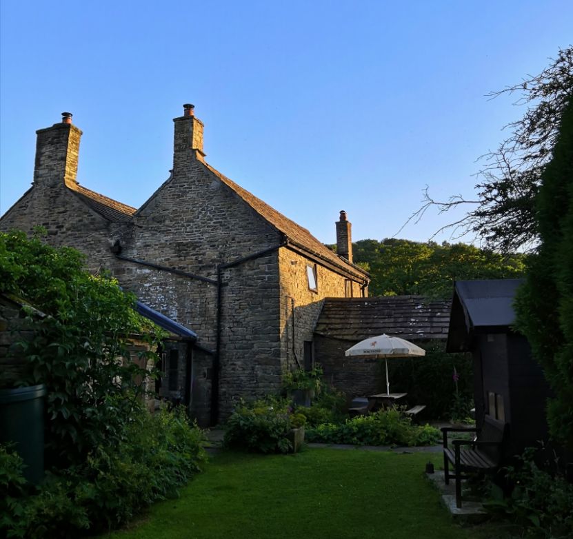 View of Goytside holiday cottage patio at dusk